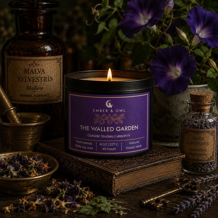 The Walled Garden candle by Ember and Owl, 8 oz black tin with a violet Outside Studies Lesson IV label